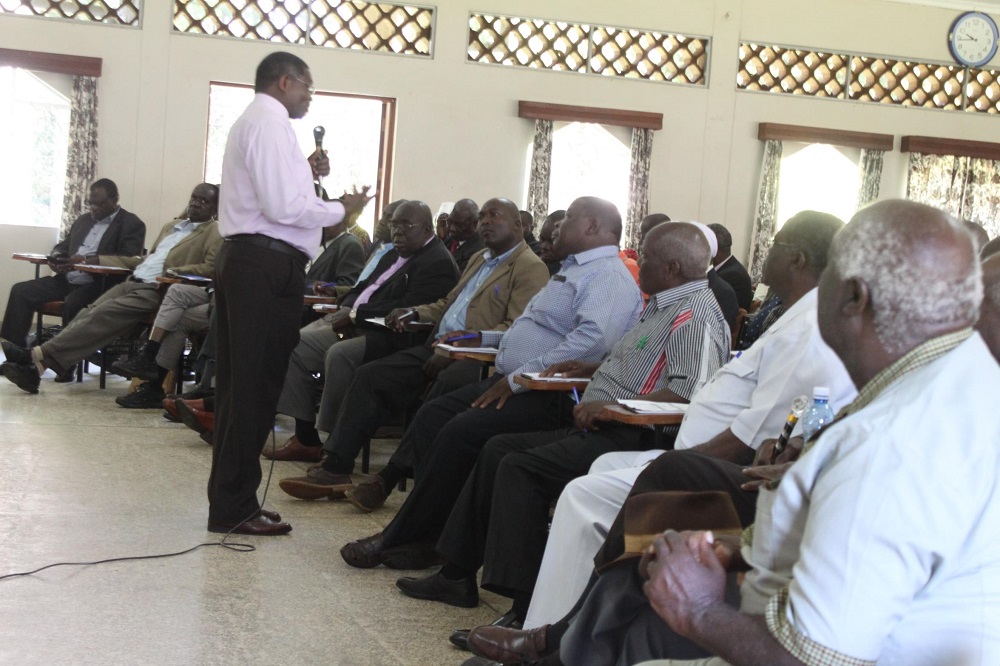 Canon Karanja stresses his point during his address to the team